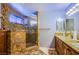 Luxurious bathroom featuring a stunning granite shower with a glass enclosure and double vanity at 6259 Santander Ave, Las Vegas, NV 89103