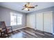 Well-lit bedroom featuring hardwood floors, double closet, and a rocking chair at 6259 Santander Ave, Las Vegas, NV 89103