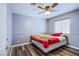 Clean bedroom with wood floor and a bed with a Mexican flag-themed blanket at 6259 Santander Ave, Las Vegas, NV 89103