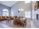 Elegant dining room with high ceilings, arched windows, a large table, and comfortable seating at 6259 Santander Ave, Las Vegas, NV 89103