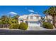Charming two-story home featuring a well-manicured lawn and a two-car garage in a sunny, suburban neighborhood at 6259 Santander Ave, Las Vegas, NV 89103