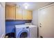 Functional laundry room with overhead cabinets, washer, and dryer at 6259 Santander Ave, Las Vegas, NV 89103