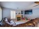 Comfortable living room with a large sofa, a fireplace, tile flooring, and plantation shutters at 6259 Santander Ave, Las Vegas, NV 89103