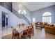 Open-concept living room featuring dining area, staircase, and comfortable seating at 6259 Santander Ave, Las Vegas, NV 89103