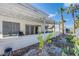 Inviting covered patio with plants and palm trees create a peaceful outdoor living space at 6259 Santander Ave, Las Vegas, NV 89103