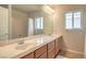 Bathroom with a double sink vanity, large mirror, and well-lit space at 6559 Musette Ave, Las Vegas, NV 89139