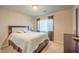 Comfortable bedroom with a queen-sized bed, soft lighting, and a dresser against the wall at 6559 Musette Ave, Las Vegas, NV 89139