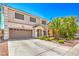 A two-story home with a two-car garage, a tile roof, and a manicured front yard at 6559 Musette Ave, Las Vegas, NV 89139