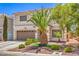 Beautiful two-story home featuring a well-maintained lawn and a mature palm tree at 6559 Musette Ave, Las Vegas, NV 89139
