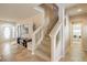 Entryway with staircase leading to upper level and featuring views to a laundry room and front door at 6559 Musette Ave, Las Vegas, NV 89139