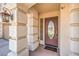 Inviting front porch featuring a decorative door with glass detail, and textured column supports at 6559 Musette Ave, Las Vegas, NV 89139