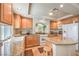 Well-lit kitchen with granite countertops, wooden cabinets, and modern white appliances at 6559 Musette Ave, Las Vegas, NV 89139