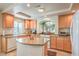 Bright kitchen with granite countertops, a central island, and modern appliances at 6559 Musette Ave, Las Vegas, NV 89139