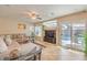 Inviting living room with tile flooring, a ceiling fan, and access to the outdoor pool area at 6559 Musette Ave, Las Vegas, NV 89139
