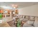 Open-concept living area with a cozy sectional sofa and views into the adjacent kitchen at 6559 Musette Ave, Las Vegas, NV 89139