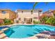 Relaxing backyard pool featuring a baja shelf, spa, patio area and well-manicured landscaping at 6559 Musette Ave, Las Vegas, NV 89139