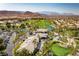 Expansive aerial view showcasing the Rhodes Ranch community clubhouse, golf course, and well-manicured landscaping at 66 Sunset Bay St, Las Vegas, NV 89148