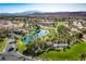 Panoramic aerial view of Rhodes Ranch featuring a lake, golf course, lush landscaping, and community homes at 66 Sunset Bay St, Las Vegas, NV 89148