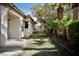 Beautiful backyard featuring a well-manicured lawn and lush tropical landscaping with lovely trees and garden at 66 Sunset Bay St, Las Vegas, NV 89148