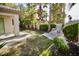Expansive backyard with lush landscaping, rock water feature, and desert flora at 66 Sunset Bay St, Las Vegas, NV 89148