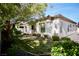 Backyard featuring lush greenery, mature trees, and landscaped garden around the perimeter of the home at 66 Sunset Bay St, Las Vegas, NV 89148