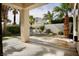 Back patio, palm trees, and rock water feature create a tranquil desert oasis at 66 Sunset Bay St, Las Vegas, NV 89148