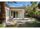 Back patio is surrounded by lush landscaping, trees, and desert plants at 66 Sunset Bay St, Las Vegas, NV 89148