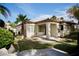 Backyard featuring tile roof, covered patio, and mature landscaping at 66 Sunset Bay St, Las Vegas, NV 89148