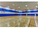 Spacious indoor basketball court with hardwood floors and multiple hoops, perfect for recreation and exercise at 66 Sunset Bay St, Las Vegas, NV 89148