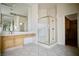 Bright bathroom featuring tiled floors, a glass shower, and vanity with large mirror at 66 Sunset Bay St, Las Vegas, NV 89148