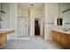 Spacious bathroom featuring tiled floors, a glass shower, dual vanity counters and large mirrors at 66 Sunset Bay St, Las Vegas, NV 89148