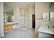 Bathroom with tiled floors, a glass shower, dual vanity counters and large mirrors at 66 Sunset Bay St, Las Vegas, NV 89148