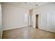 Bright bedroom featuring light-colored walls, wood-look flooring, and a ceiling fan for comfortable living at 66 Sunset Bay St, Las Vegas, NV 89148