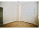 Spare bedroom featuring wood floors, white trim, and a closet with bi-fold doors at 66 Sunset Bay St, Las Vegas, NV 89148