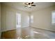 Bright bedroom featuring light-colored walls, wood-look flooring, and a ceiling fan for comfortable living at 66 Sunset Bay St, Las Vegas, NV 89148