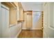 Walk-in closet with shelving, wood-look flooring, and hanging racks for optimized storage at 66 Sunset Bay St, Las Vegas, NV 89148