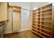 Walk-in closet with shelving, wood-look flooring, and hanging racks for optimized storage at 66 Sunset Bay St, Las Vegas, NV 89148