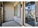 An embellished front door with decorative glass, stonework detail, and a modern light fixture at 66 Sunset Bay St, Las Vegas, NV 89148