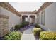 The entryway showcases a beautifully landscaped walkway and arched entrance leading to the front door at 66 Sunset Bay St, Las Vegas, NV 89148