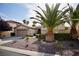 Beautiful single-story home featuring desert landscaping, palm trees, and a well-maintained yard at 66 Sunset Bay St, Las Vegas, NV 89148