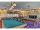 This game room features billiard tables, ping pong, a fireplace, and natural light at 66 Sunset Bay St, Las Vegas, NV 89148