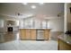 Open kitchen with an island and stainless dishwasher offers a great view of the cozy fireplace at 66 Sunset Bay St, Las Vegas, NV 89148