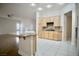 Open kitchen with granite counters, a large island, and white tile floors offers ample counter space at 66 Sunset Bay St, Las Vegas, NV 89148