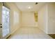 An empty living room showcases tile floors, neutral paint, a decorative window, and a glass front door at 66 Sunset Bay St, Las Vegas, NV 89148