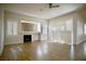 Sun-filled living area with fireplace, hardwood floors, and large windows with plantation shutters at 66 Sunset Bay St, Las Vegas, NV 89148