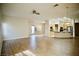 Open concept living space featuring wood floors, leading into a kitchen with light wood cabinets and stainless appliances at 66 Sunset Bay St, Las Vegas, NV 89148