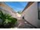 Narrow side yard featuring rock landscaping and a high stucco wall providing privacy to the property at 66 Sunset Bay St, Las Vegas, NV 89148