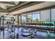 Well-equipped weight room with dumbbells, weight racks, and panoramic windows overlooking greenery at 66 Sunset Bay St, Las Vegas, NV 89148