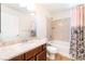 Bathroom with a wooden vanity, a white sink, and a bathtub with a shower at 6821 Treble Clef Ave, Las Vegas, NV 89139