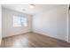 Bright bedroom with hardwood floors and a window with blinds at 6821 Treble Clef Ave, Las Vegas, NV 89139